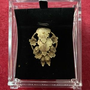 One ornate brass shoe clip.